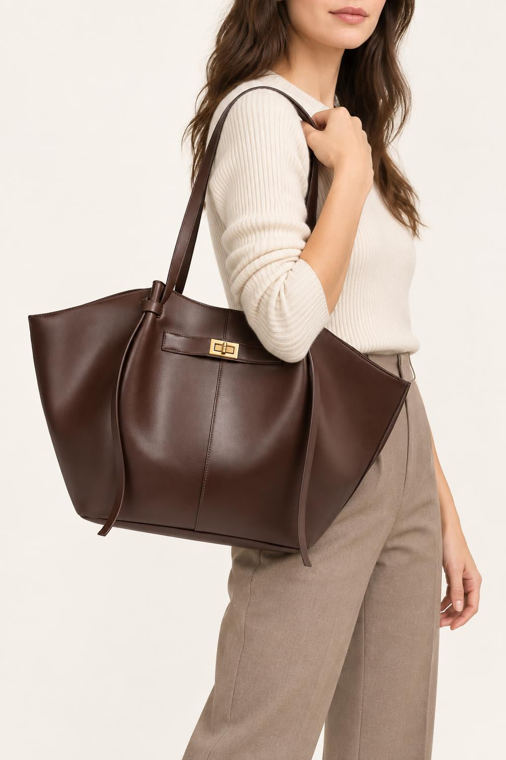 Women's Soft PU Winged Tote Bag with Gold-Tone Clasp — carrying view