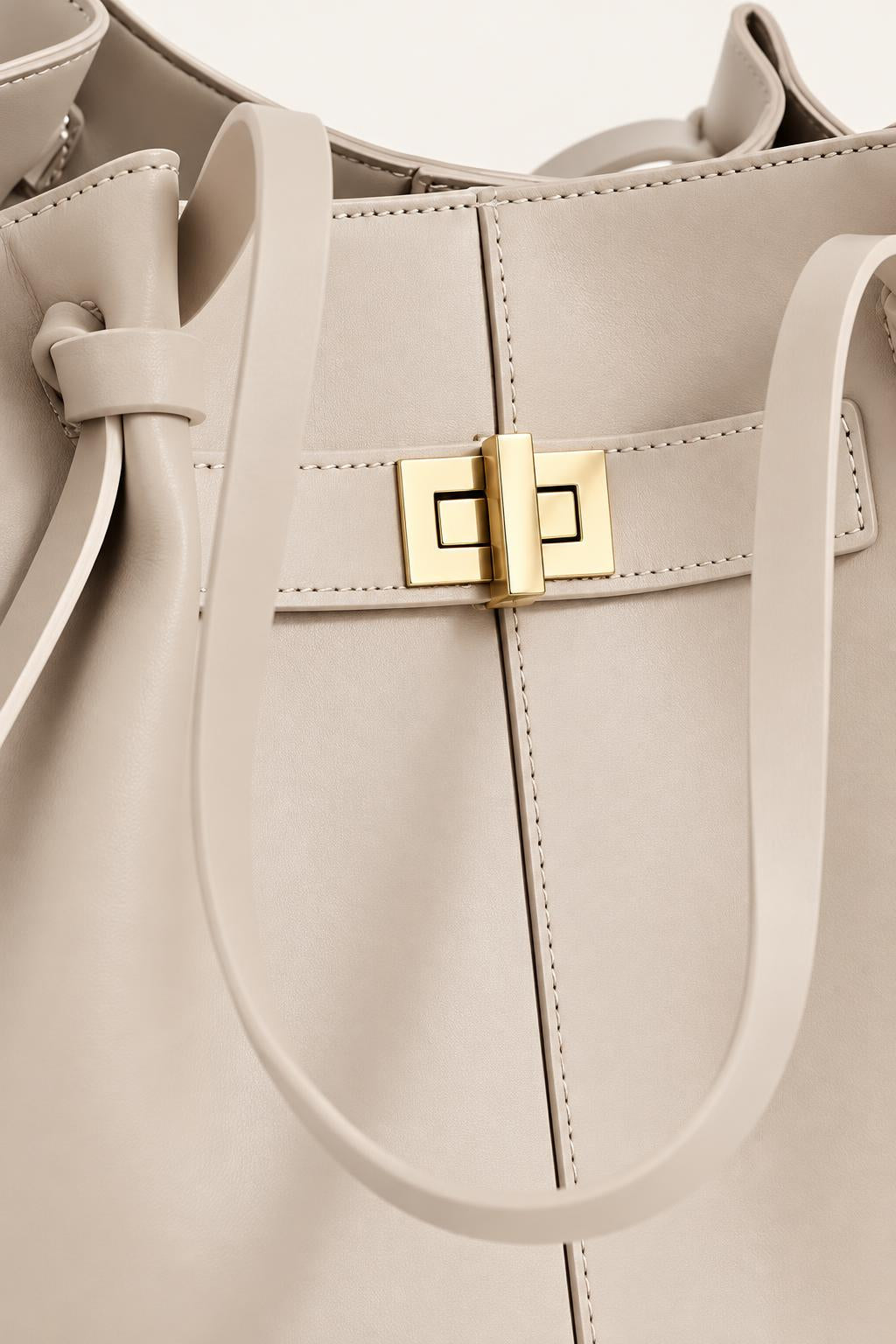 Women's Soft PU Winged Tote Bag with Gold-Tone Clasp — carrying view